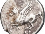 a close up of a silver coin with a bird on it