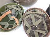 three military helmets are sitting on a table next to each other