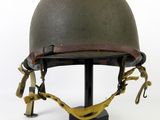 an old helmet on a stand on a white background