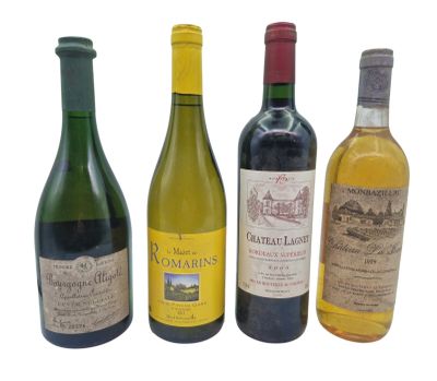 several bottles of wine are lined up on a white surface