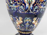 a blue vase with a design on it on a white background