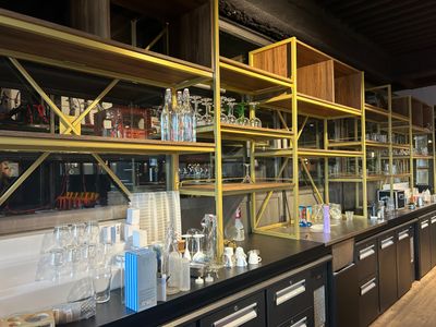 many bottles and glasses on the shelves in the store