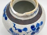 a blue and white vase sitting on a white surface