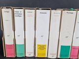 several books are lined up in a row on a table