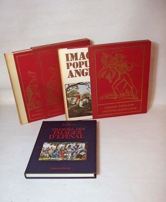 three books sitting on a white surface one is red and the other is blue
