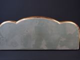 a white and gold sculpture of a cloud on a black background