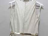 the back of a dress hanging on a hanger on a wall