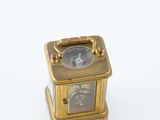 a small clock that is sitting on top of a table