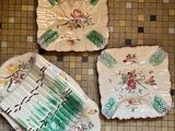 three plates that are sitting on a tiled floor