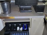 an image of a computer desk with a drawer full of items