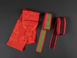 two red and green ties on a black surface