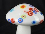 a white mushroom with multi colored flowers on it