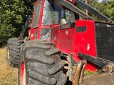 a red tractor that is parked in the grass