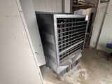 a metal cooler sitting in the middle of a room