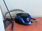 a vacuum that is sitting on the floor next to a broom