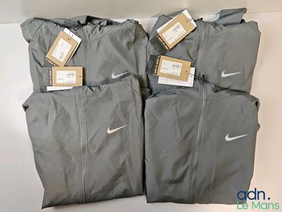 three pairs of nike tracksuits with tags on them