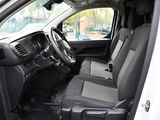 the interior of a white truck with black seats and a steering wheel