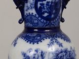 a blue and white vase sitting on top of a table