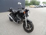 a black motorcycle parked in a parking lot next to a building