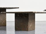two tables that are sitting next to each other on the floor