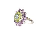 an image of a close up of a ring with purple and green stones