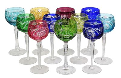 several different colored wine glasses are lined up in a row
