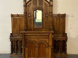 a wooden altar with a mirror on top of it