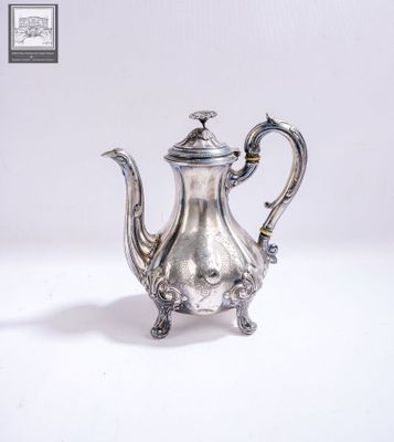 silver plated tea pot on stand on white surface with white background