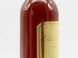 an image of a bottle of liquor sitting on top of a white surface