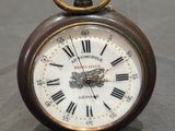 a small clock with roman numerals on the face