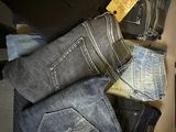 several pairs of jeans are stacked on top of each other in a drawer