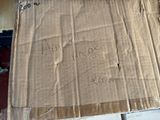 a cardboard box with writing on it sitting on the floor