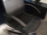 a blurry photo of a chair and a desk in a room