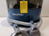 an image of a blue and silver vacuum cleaner on a white surface