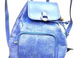 a blue backpack that is sitting on a white surface