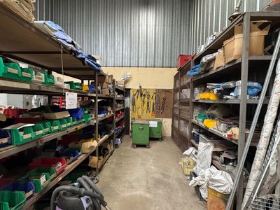 a room with a lot of shelves and bins in it