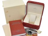 a red box with a watch and a book in it