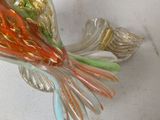 a glass bird that is sitting on top of a table