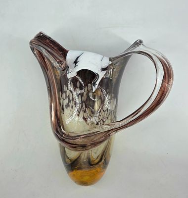 a glass vase with a cow head on top of it