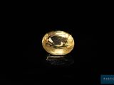a yellow diamond on a black surface