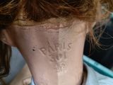 a mannequin head with writing on it in a barber shop