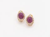 a pair of ruby and diamond earrings