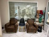 three chairs and a chair in a room with a large window