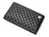 a black quilted wallet with a metal button on the front