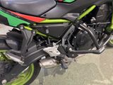a green and black motorcycle parked in a showroom