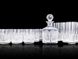 a lot of glasses and a decanter on the table