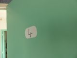 a clock on the wall in a room with a green wall