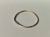 a close up of a gold ring on a white surface