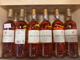 several bottles of wine are lined up on a shelf