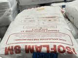 a pile of bags of cement sitting on top of each other